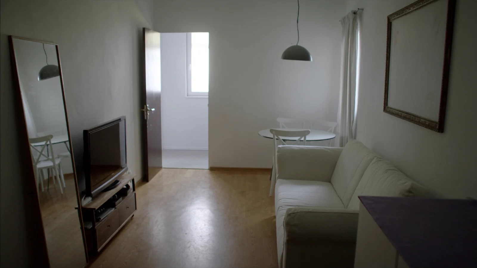 Sala de apartamento compacto e bem iluminado